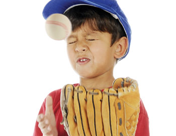 kid getting hit with a baseball